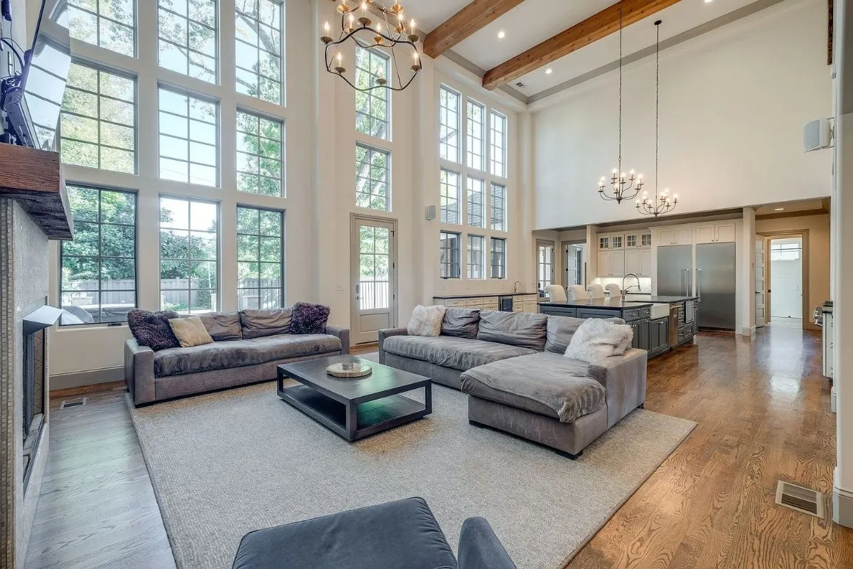 Great room with a two-story wall of windows and a fireplace