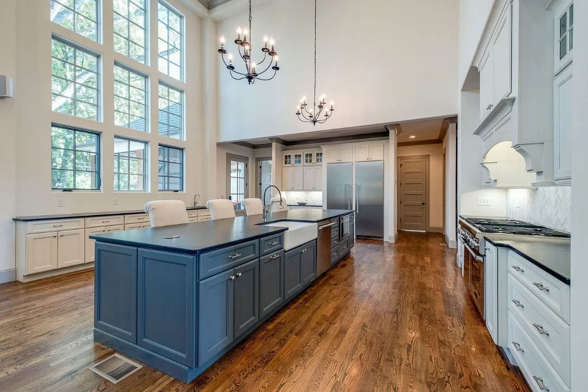 Kitchen with a navy island and white perimeter cabinets