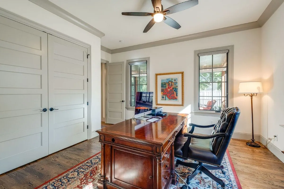 Home office with crown molding and two windows