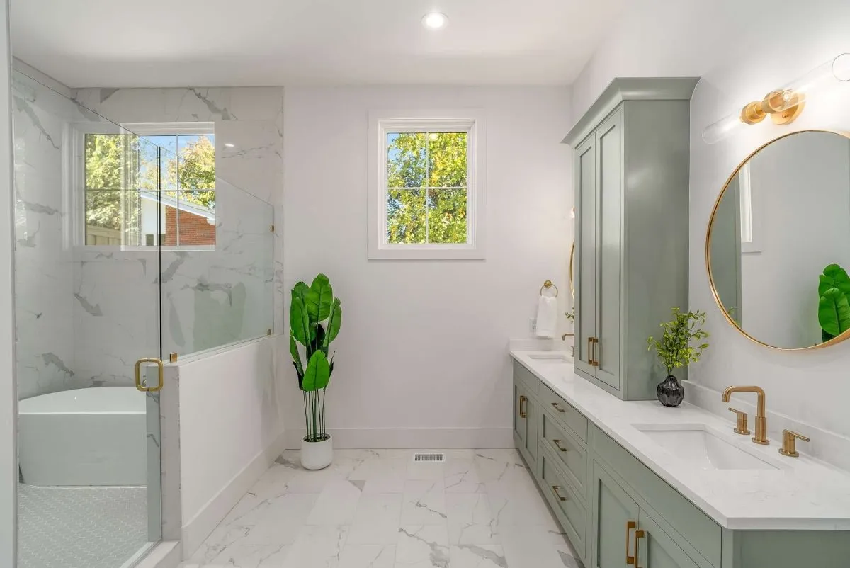 Primary bath with marble tile and a freestanding tub
