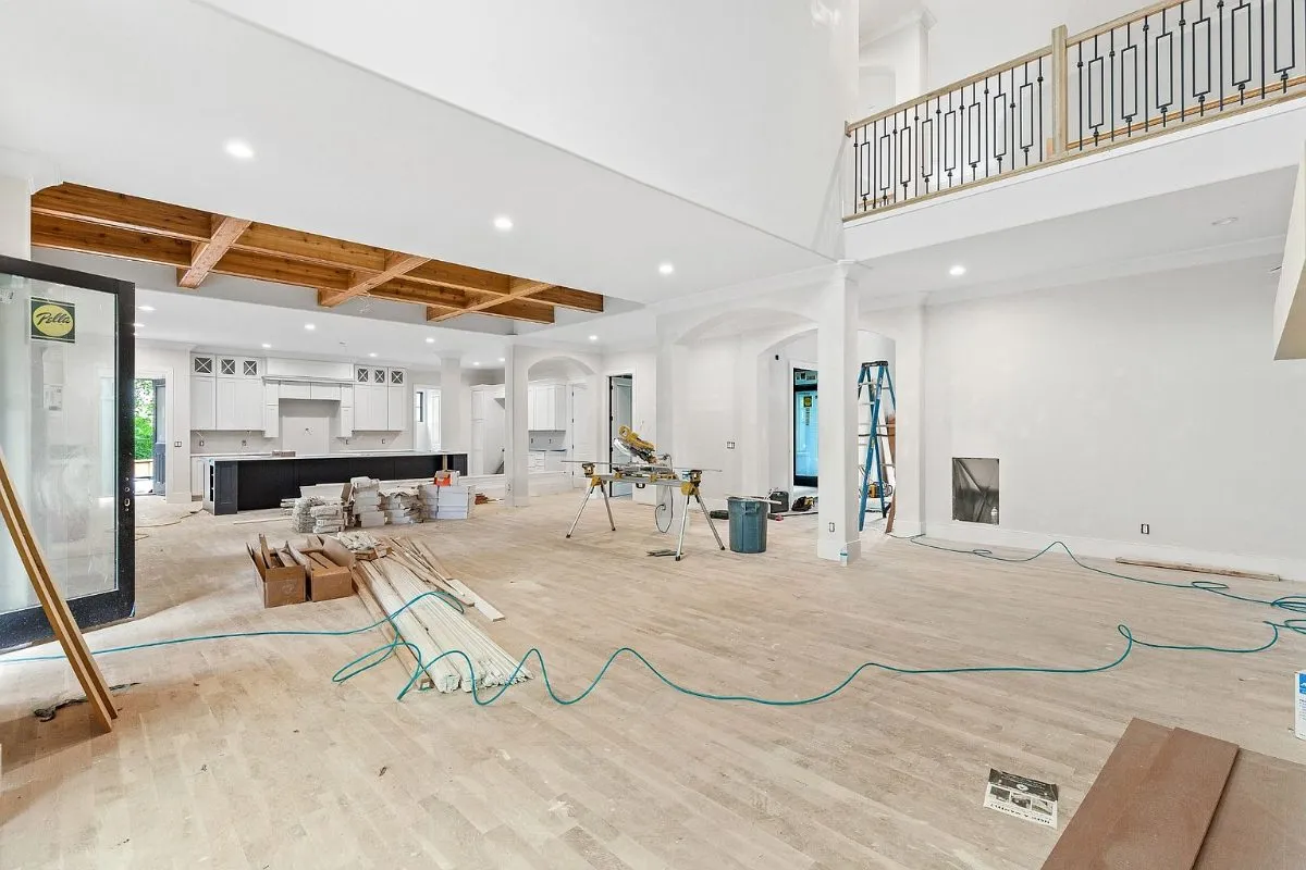 Open main floor during finishing, the kitchen beyond